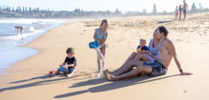 Family playing on the beach in Kiama
