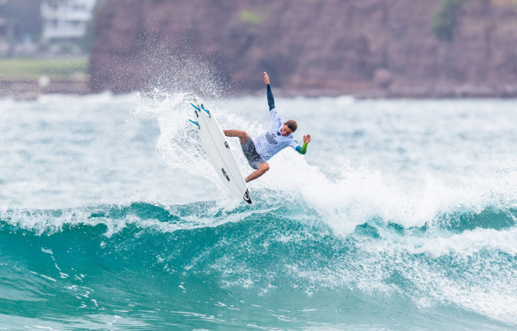 Man surfing at the World Juniors Competition