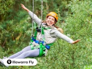 Girl on a zip line above the trees at Illawarra Fly